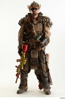 Ryan Sutton in Junk Town Postapocalyptic Bobby Suit holding gun…